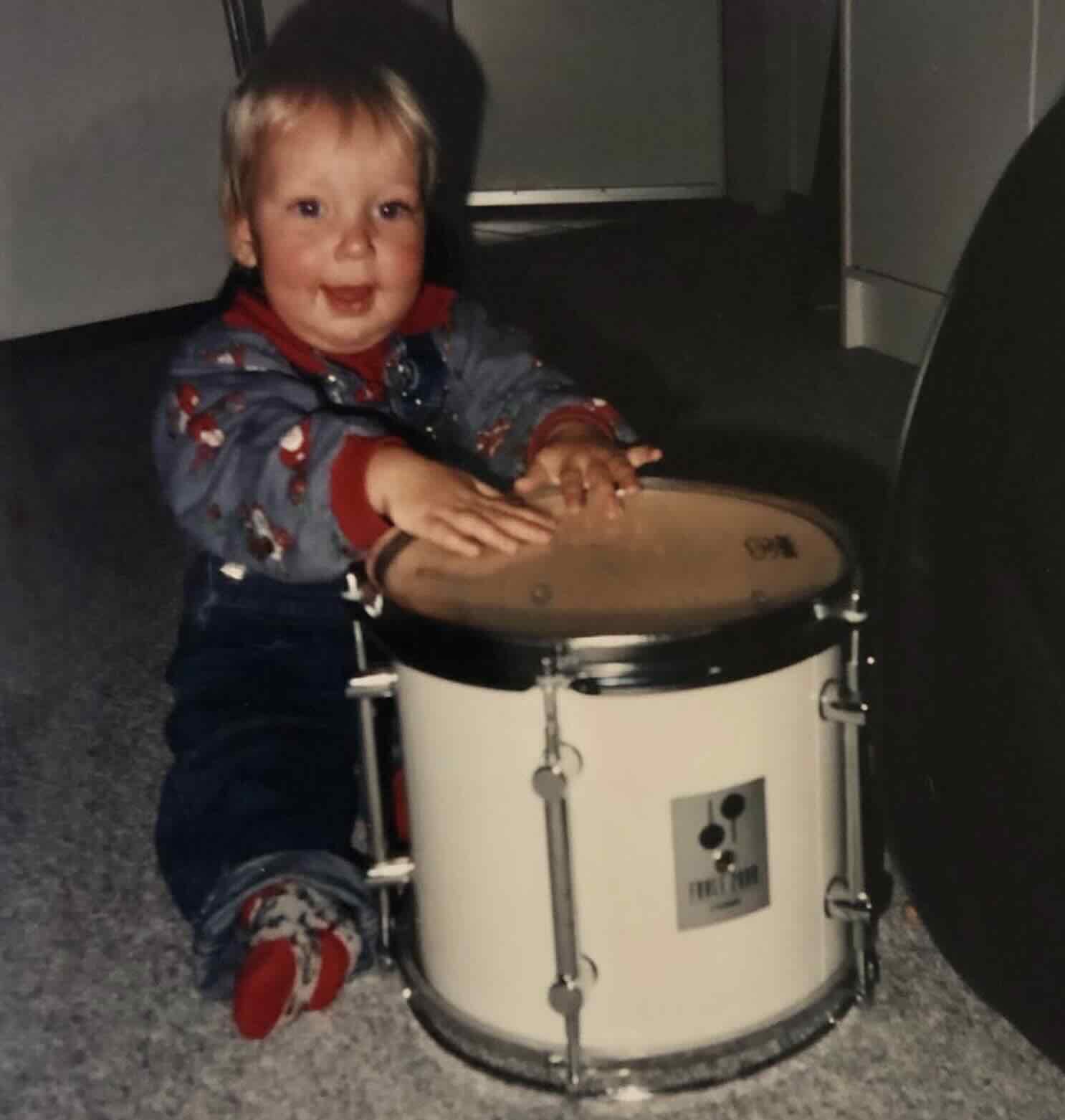 Photo of Dirk as a baby with a drum